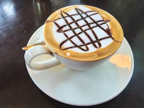 Hot coffee in white cup on the  table.