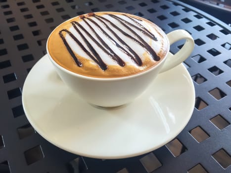 Hot coffee in white cup on the  table.