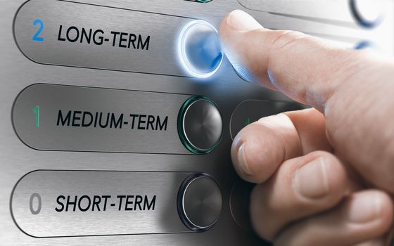 Man pushing an elevator buttons where it is written long term. Investment Concept. Composite image between a hand photography and a 3D background.