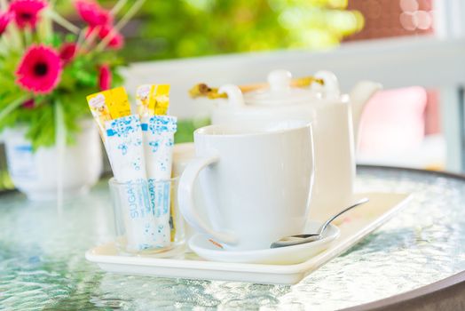 Hot coffee and a teapot on the table.