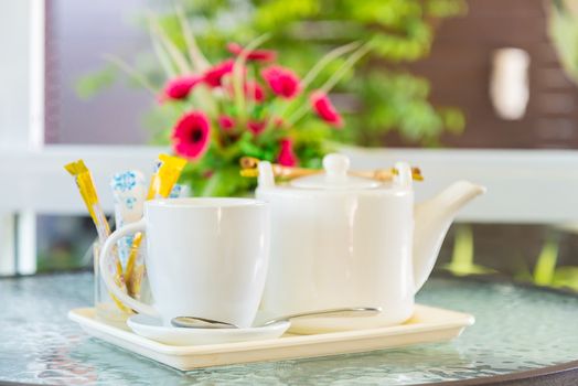 Hot coffee and a teapot on the table.