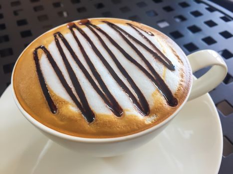 Hot coffee in white cup on the  table.