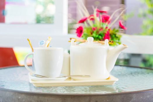 Hot coffee and a teapot on the table.