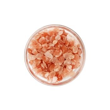 Close up one glass bowl saltcellar full of large crystals pink Himalayan salt isolated on white background, elevated top view, directly above