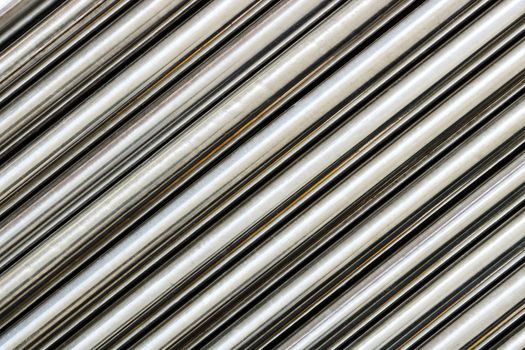 Texture of chrome steel pipe sort in diagonal, abstract background