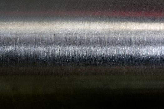 Texture of reflection on stainless steel pipe in dark room, abstract background