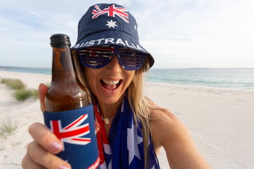 Ausralian culture, good times, lazy weekends chilling on the beach, woman holding a beer.  Australian culture, Australia Day, aussie pride, travel, vacation