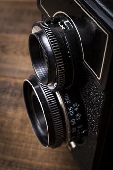 Old Camera Closeup on Brown Wood Baclground