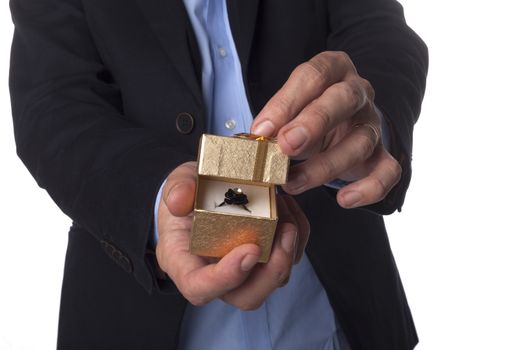 Man Hand in Suit Holding Golden Jewelry Box Isolated on White Background