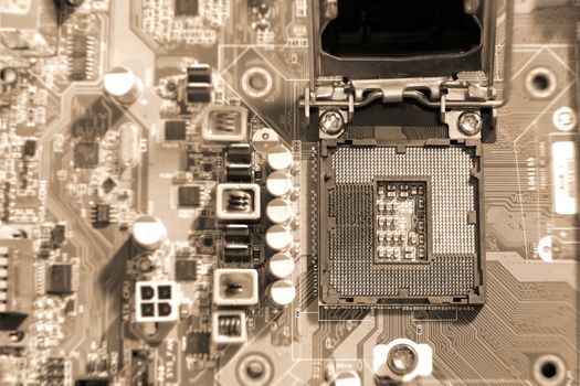 Electronic circuit boards on brown background with CPU socket, selective focus