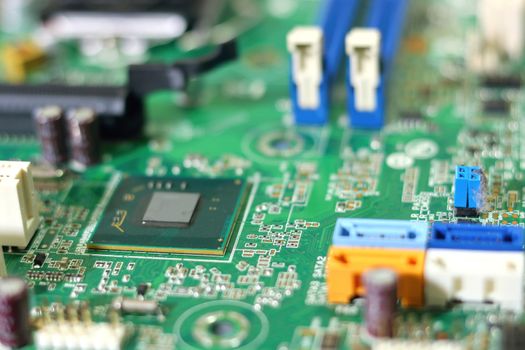 Electronic circuit boards on green background, selective focus