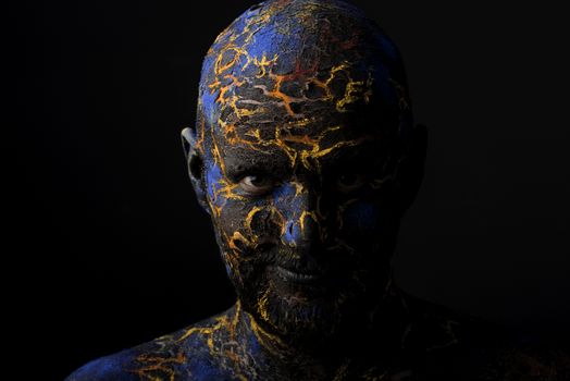 Conceptual Portrait of a brutal man painted in face art style over black background