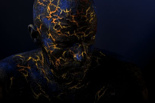 Conceptual Portrait of a brutal man painted in face art style over black background