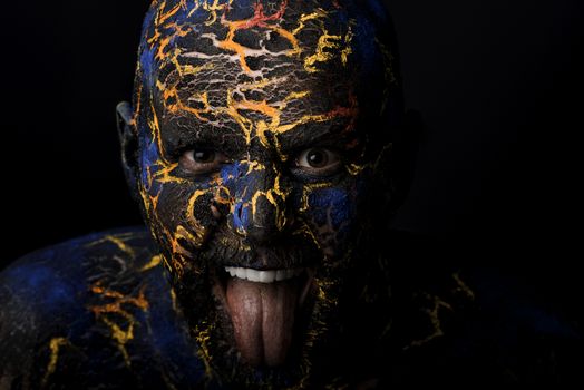Conceptual Portrait of a brutal man painted in face art style over black background