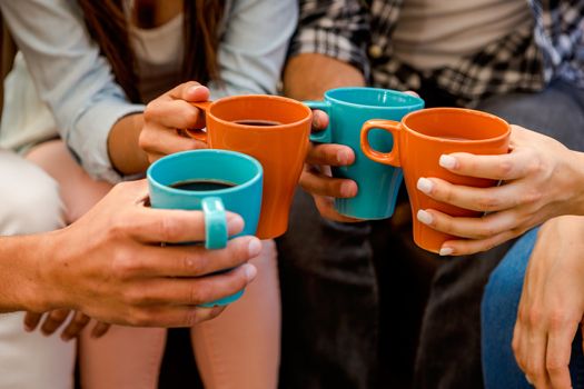 Group of friends making a toast with coffee