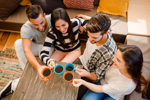 Group of friends making a toast with coffee