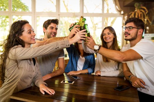 Group of friends hanging out and making a toast with beer 