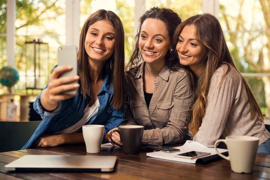 Groups of female firends making a selfie during a pause on the studies