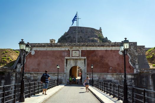 Corfu, Greece - August 25, 2018: Fortezza Vecchia (Old Fortress, Corfu) entrance with tourists on the bridge.