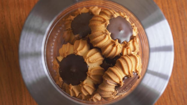 Chocolate cookies in a glass jar on wooden table. The concept of kitchen and food