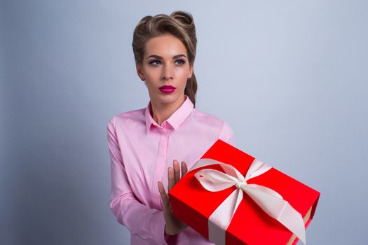 Portrait of a young woman refusing holiday gift box