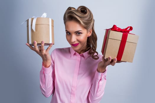 Young happy woman holding two presents with bows