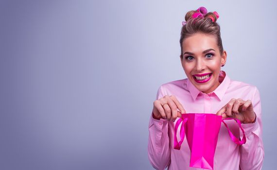 Shopping, sale, christmas and holiday concept - smiling woman with small shopping gift bag