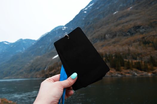 Badge blank in black against the background of the Norwegian mountains. Travel concept