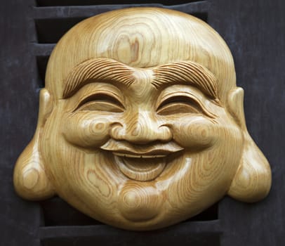 Hanoi, VIETNAM - JANUARY 12, 2015 - Vietnamese wooden smiling mask