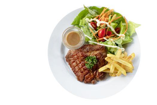 Grilled steak with french fries and fresh vegetables on white plate