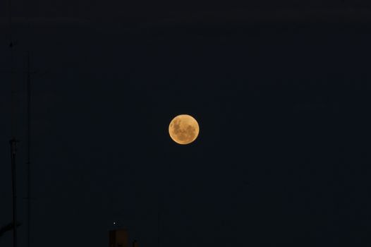 The full moon before the eclipse over a dark sky background