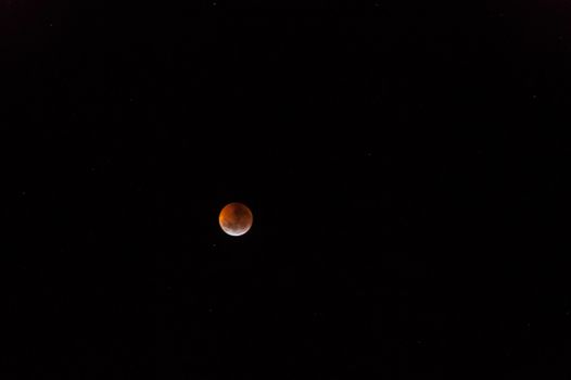 Total lunar eclipse. The bloody moon over a dark sky
