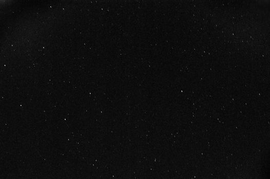 A black and white pic of the Dark Sky full of stars during the total lunar eclipse