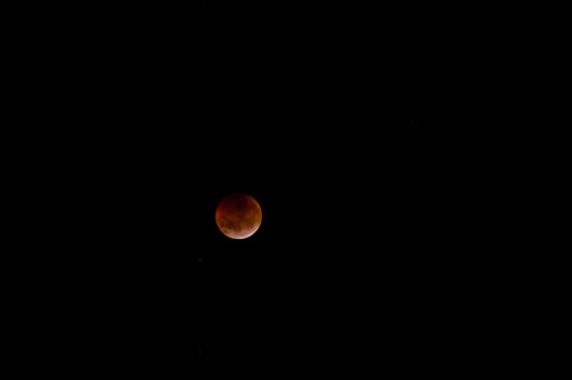 Total lunar eclipse. The bloody moon over a dark sky