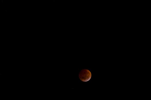 Total lunar eclipse. The bloody moon over a dark sky