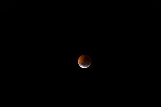 Total lunar eclipse. The bloody moon over a dark sky