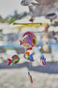 Handmade dream catcher in the shape of a fish: a souvenir from Mexico.