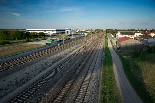 Train tracks in a countryside with industry at Maisach in Bavaria, Germany