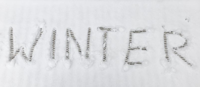 handwriting text letters winter in winter landscape in the white snow