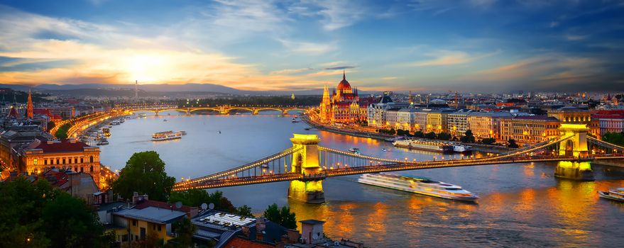 Parliament and bridges of Budapest illuminated in evening, Hungary