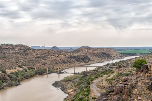 View downstream of the Vanderkloof Dam in the Orange River on the border of the Free State and Northern Cape Provinces. The single lane road bridge is visible