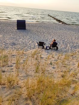 Rear view of a woman on the beach in a deck chair