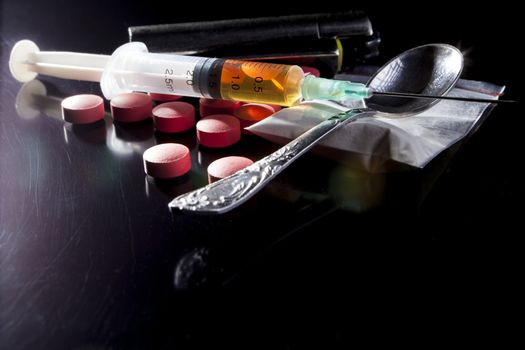 Narcotics on black table with some reflection