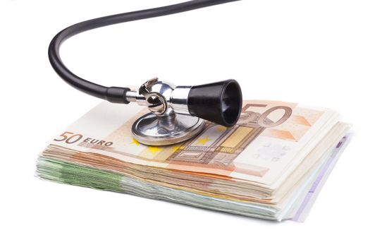 Black stethoscope  on pile of euro banknotes closeup isolated on white background