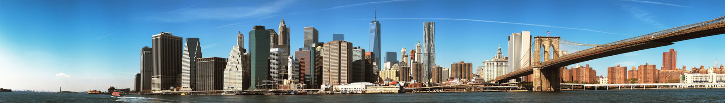 The New York City Downtown skyline at the afternoon w Brooklyn Bridge