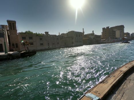 Creek in Dubai with view of pier and buildings by the creek.