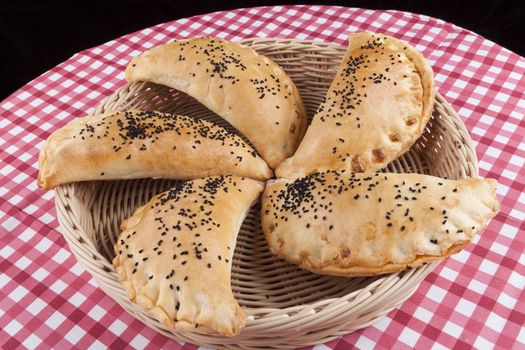 Filled pastry close-up in basket on round table