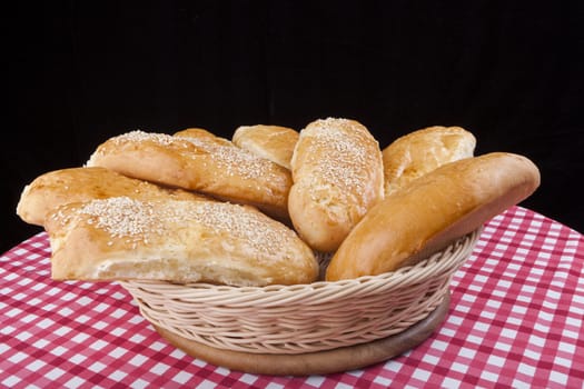 Sesame buns in basket on black backgrund