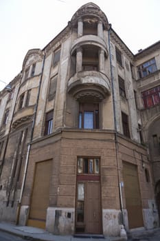 Old European corner building in Romania with bright daylight