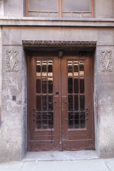 Old rusty exterior door with glass windows